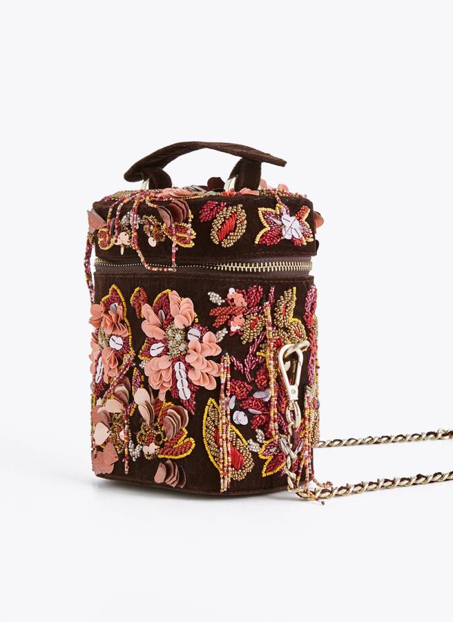 Este es uno de nuestros favoritos. Con base de terciopelo marrón, cuajado de flores y con una forma muy original. Es de Uterqüe, costaba 79 euros y se ha quedado en 49,95.