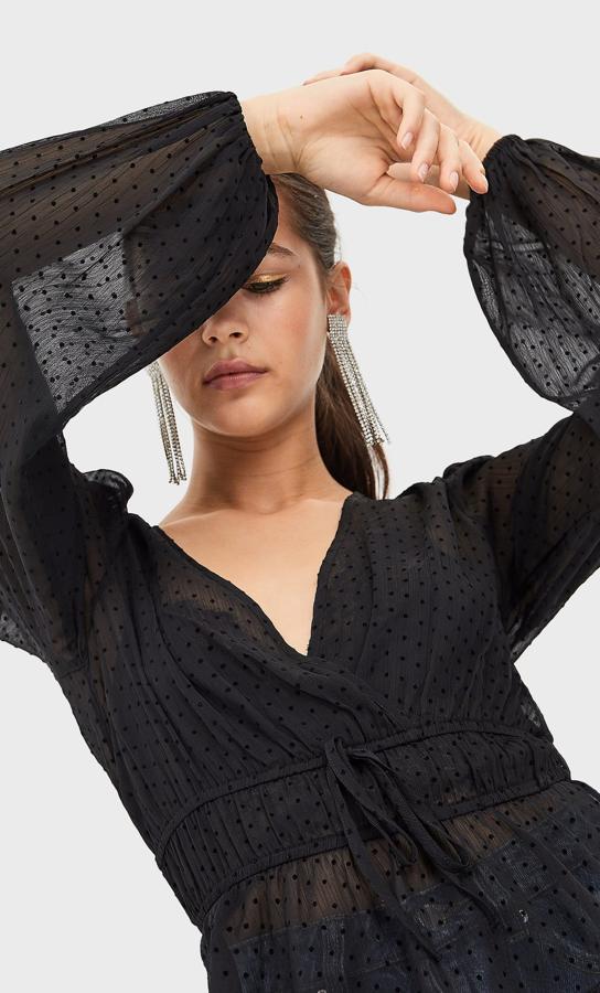Blusa negra de plumetti con los lunares a tono y detalle elástico en la cintura (15.99 euros).