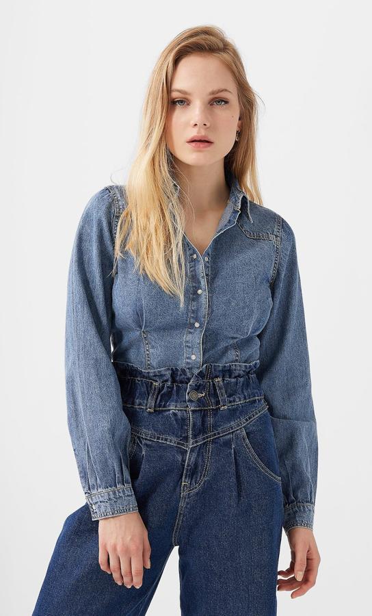 Una de nuestras favoritas, por ese tono desgastado que nos recuerda al rancho que nunca tendremos. Con botones efecto perla y pinzas en la cintura, esta camisa ajustada cuesta 25,99 euros y está disponible en las tallas S, M y L.