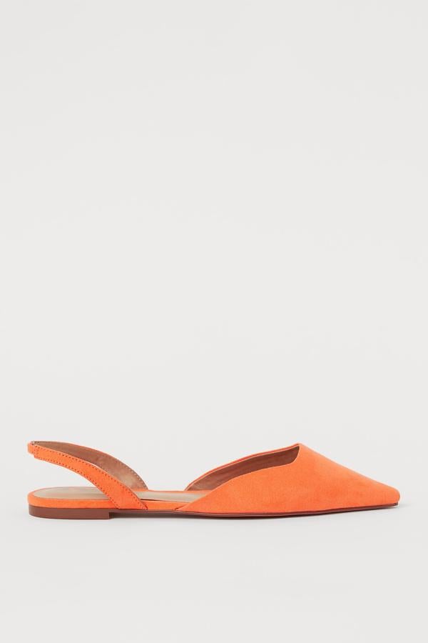 Con talón al descubierto, estas sandalias planas en color naranja de ante sintético cuentan con forro de satén y tienen un precio de 14,99 euros.