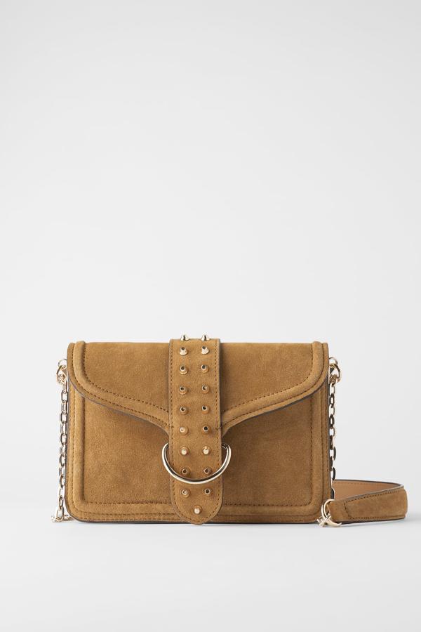 En color marrón con asa de hombro con cadena dorada, este bolso bandolera de piel con cuerpo de serraje con fuelle tiene un precio de 49,95 euros.