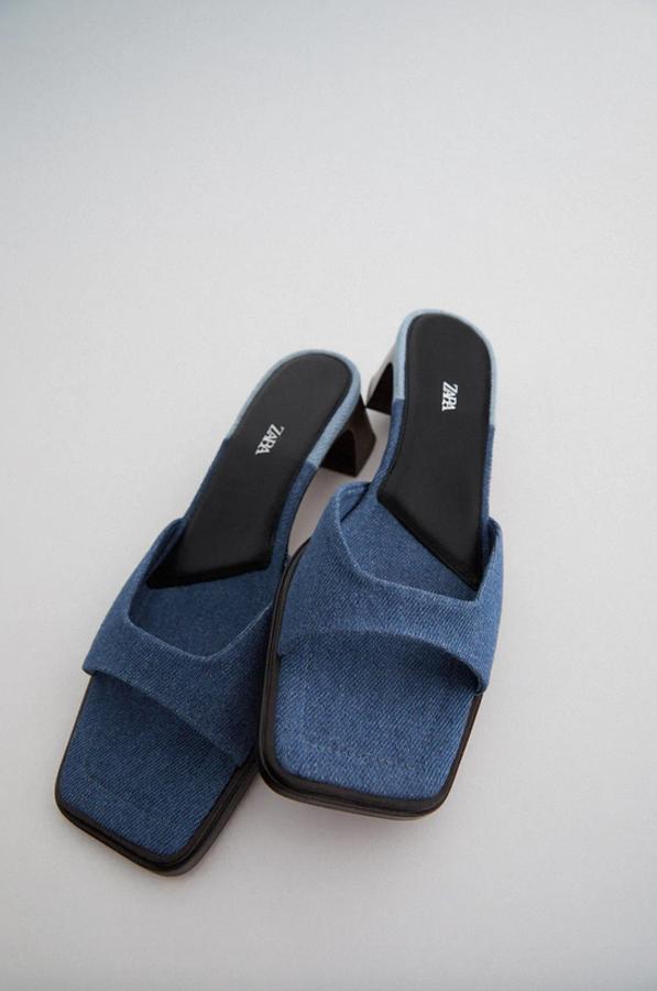 Con tira con escote cuadrado en el empeine, estas sandalias de tacón medio ancho en efecto madera de Zara acaban en punta cuadrada. Cuestan 39,95 euros y están disponibles entre los números 35 y 42.