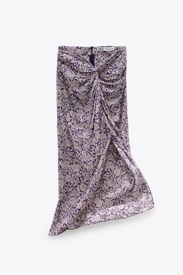 En color malva, esta falda midi con nudo delantero cuenta con bajo con abertura frontal y cierre en la espalda mediante cremallera oculta. Tiene un precio de 29,95 euros.