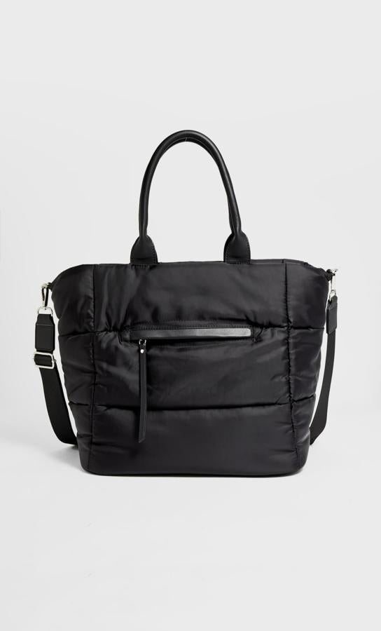 En tejido de nylon, con detalles en efecto piel y compartimento exterior con cremallera, este bolso shopper con efecto acolchado y asas de hombro y de mano es de Stradivarius tiene un precio de 19,99 euros.