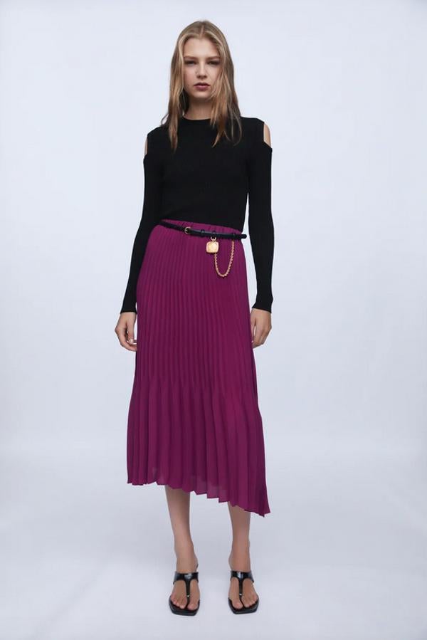 En color púrpura, con cintura elástica y dos plisados diferentes, esta bonita falda midi con bajo asimétrico es de Zara y cuesta 25,95 euros. Está disponible entre las tallas XS y XL.