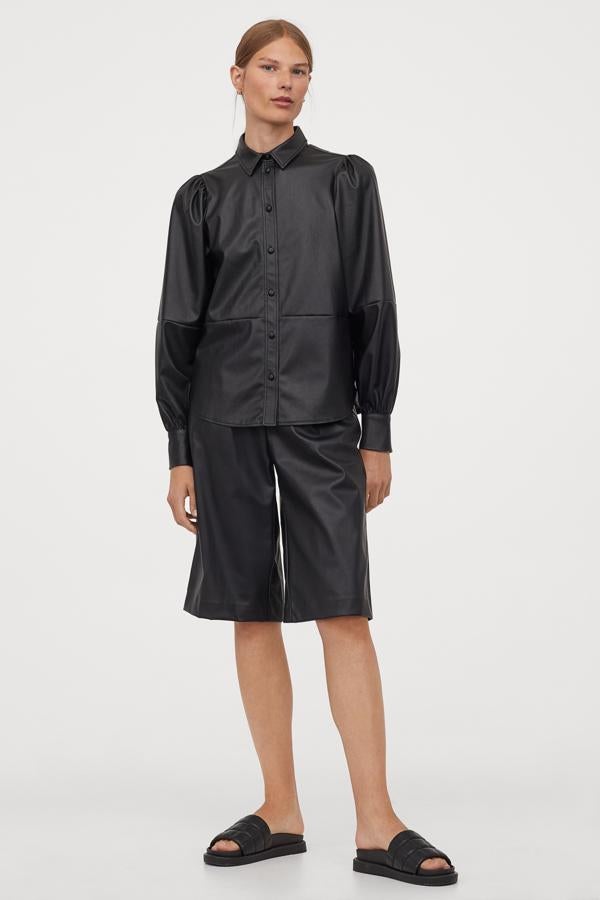 Camisa recta en piel sintética con cuello de pico, mangas largas abullonadas con costura en cintura y mangas, botones revestidos en el pecho y los puños, de H&M (29,99 €).