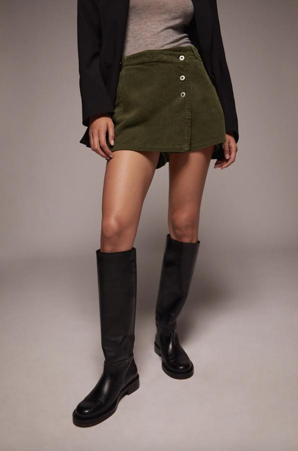 Otro de los tejidos tendencia de este otoño es la pana y en Zara la han llevado a esta falda pantalón en color caqui con bolsillos delanteros y bolsillos de plastrón en la espalda. Con cierre frontal de cremallera y botones metálicos cruzados, tiene un precio de 22,95 euros y está disponible entre las tallas XS y XL.