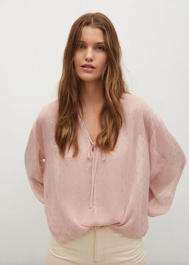Detalles metalizados para esta blusa rosa de Mango de diseño ancho y con escote de pico con tiras al cuello. Con mangas largas abullonadas y puños abotonados, está disponible entre las tallas S y XL por 39,99 euros.