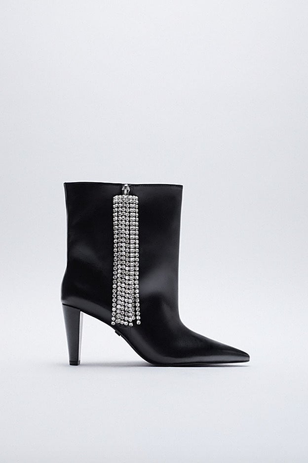 Botas de piel con un adorno lateral de flecos de pedrería.