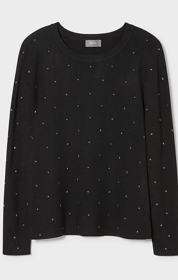 En color negro con adornos metálicos en forma de estrella, este jersey de punto fino y escote redondo tiene un precio de 19,99 euros y también está disponible en rojo
