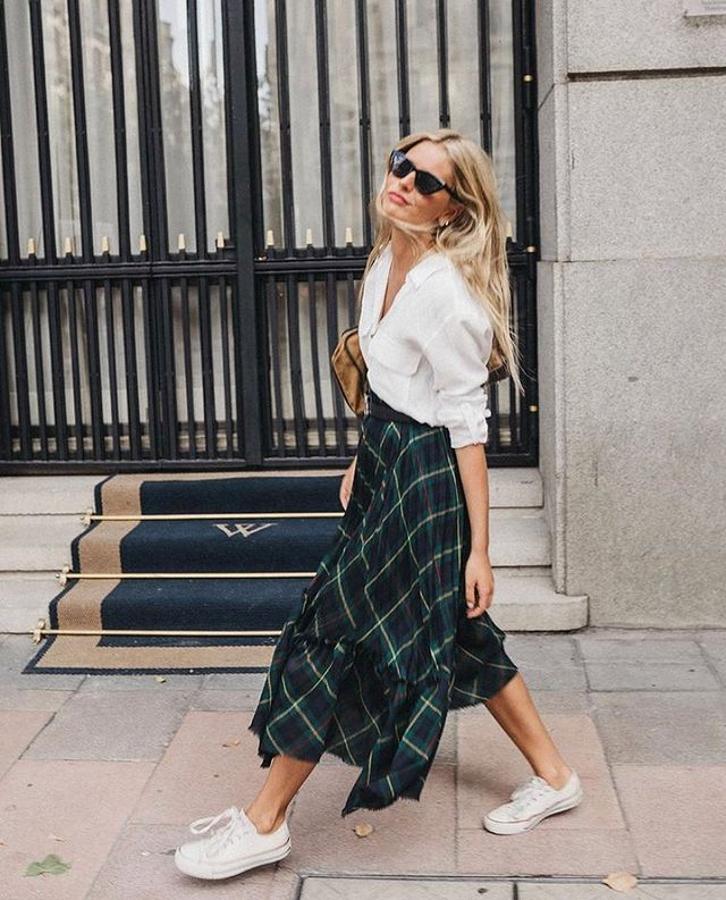 Las faldas midi reinaron durante todo el verano compañadas porsimples pero efectivas zapatillas blancas. @mariagarrido