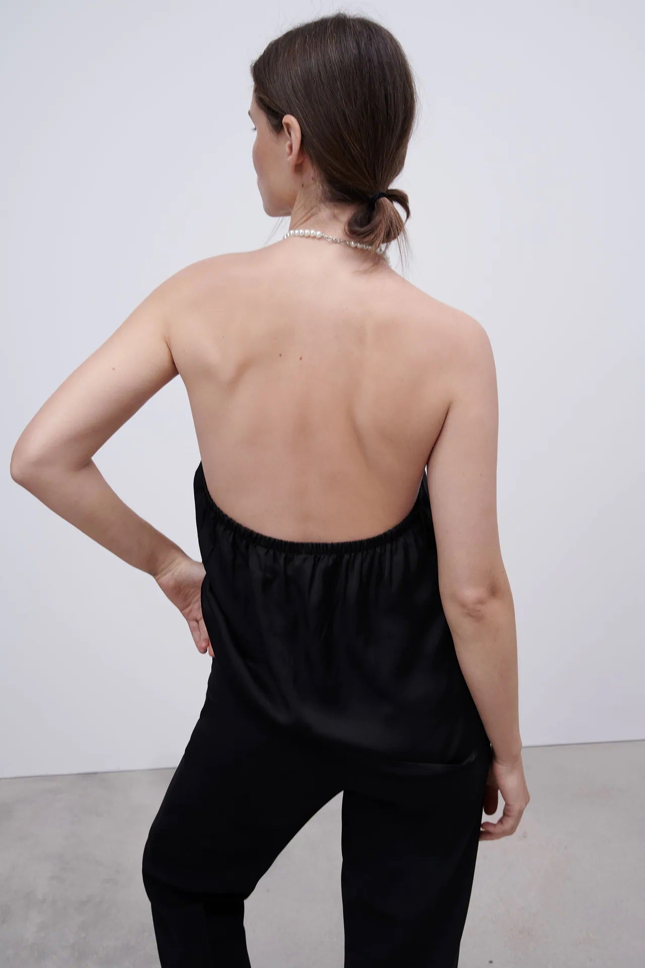 Top negro con cuello halter de perlas y escote en la espalda. (19,95 euros).