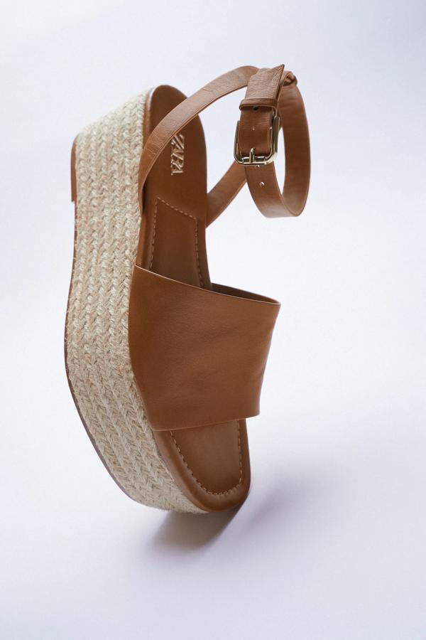 Esta cuña con corte de piel en color marrón y plataforma forrada cuenta con cierre mediante hebilla al tobillo y tiene una altura de 6,8 centímetros. Es de Zara y tiene un precio de 39,95 euros.