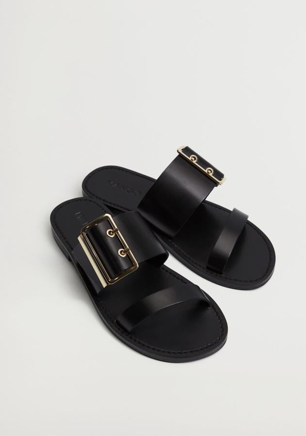 Fabricada en piel 100% bovino de color negro, esta sandalia plana con punta redondeada y cierre de hebilla es de Mango y tiene un precio de 39,99 euros.