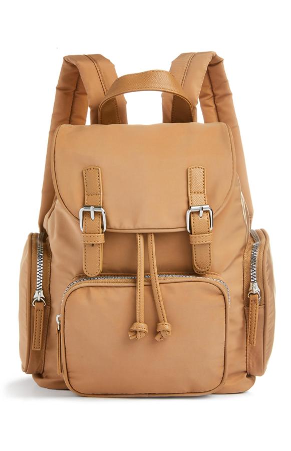 Esta mochila de nailon en color camel con hebillas pequeñas, varios bolsillos con cremallera y asas acolchadas tiene un precio de 12 euros.