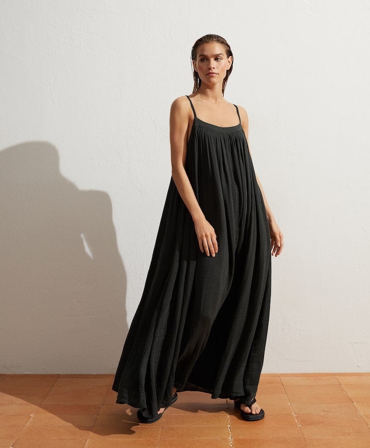 Prueba la comodidad absoluta con vestido negro de corte maxi de Oysho. (39,99 euros).