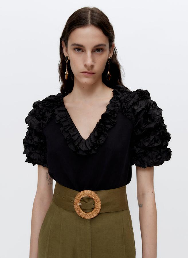 En color negro, con escote de pico y manga y escote combinados con tejido fruncido a tono, esta camiseta de manga corta ha pasado de 69 euros a 39,95 euros y solo queda en la talla S. 