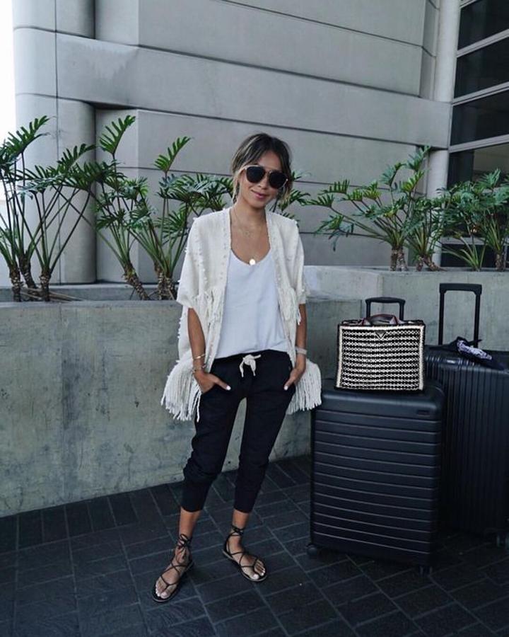 Chaleco con flecos + camiseta blanca + pantalón tipo jogger + sandalias planas