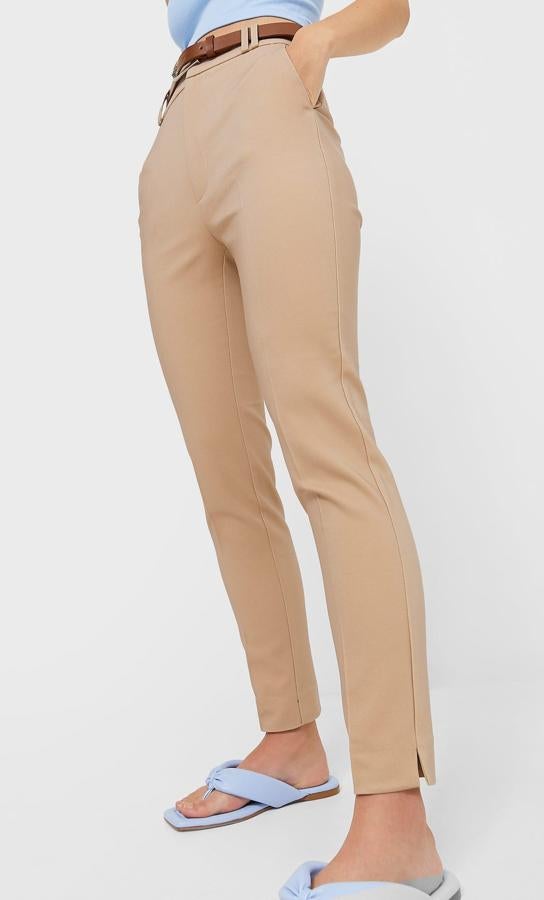 Disponible en rosa empolvado, beige, piedra o negro, este pantalón de tiro alto de Stradivarius con bolsillos de vivo en la espalda y bajo con aberturas laterales viene con detalle de cinturón y cuesta 19,99 euros. Todos los tonos podemos encontrarlos entre las tallas 32 y 44. 