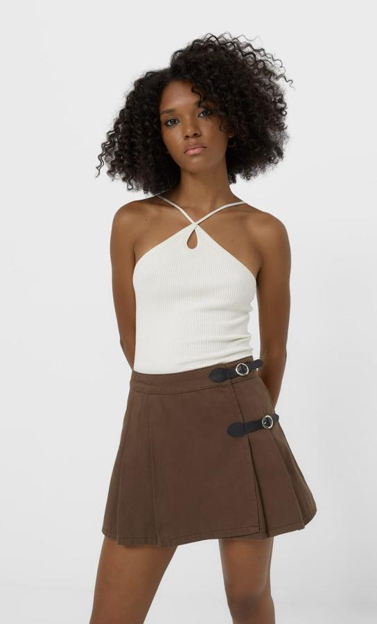 Con tablas laterales y detalle de hebillas a contraste en negro, esta minifalda marrón de Stradivarius cuesta 19,99 euros y podemos encontrarla entre las tallas XS y XL. 