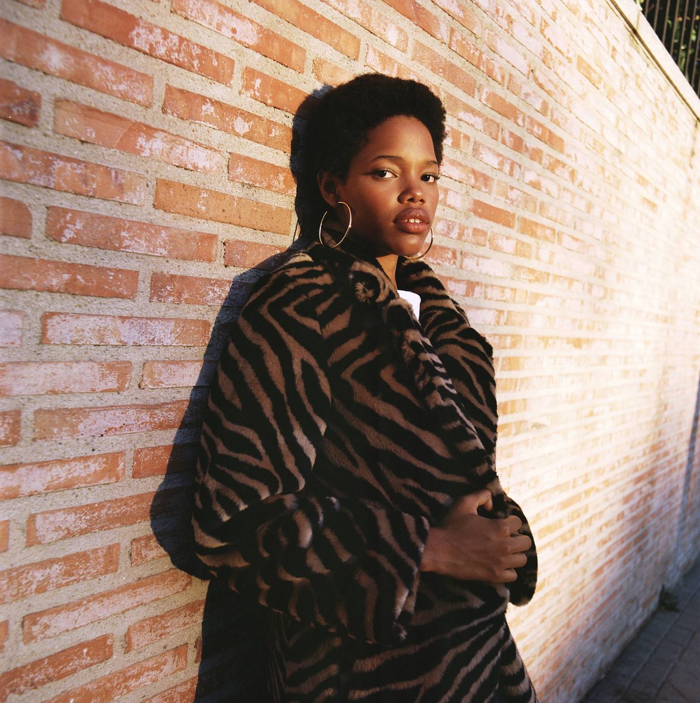 Abrigo de Hugo Boss, camiseta de Jean Paul Gaultier y pendientes de Zara.