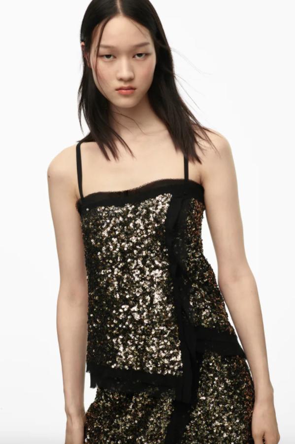 Otra de las prendas de la colección edición limitada de Zara es este top de escote recto y tirantes finos cruzados en la espalda con lentejuelas en color cobre y acabados desflecados a contraste en negro. Tiene un precio de 49,95 euros y está disponible entre las tallas XS y L.