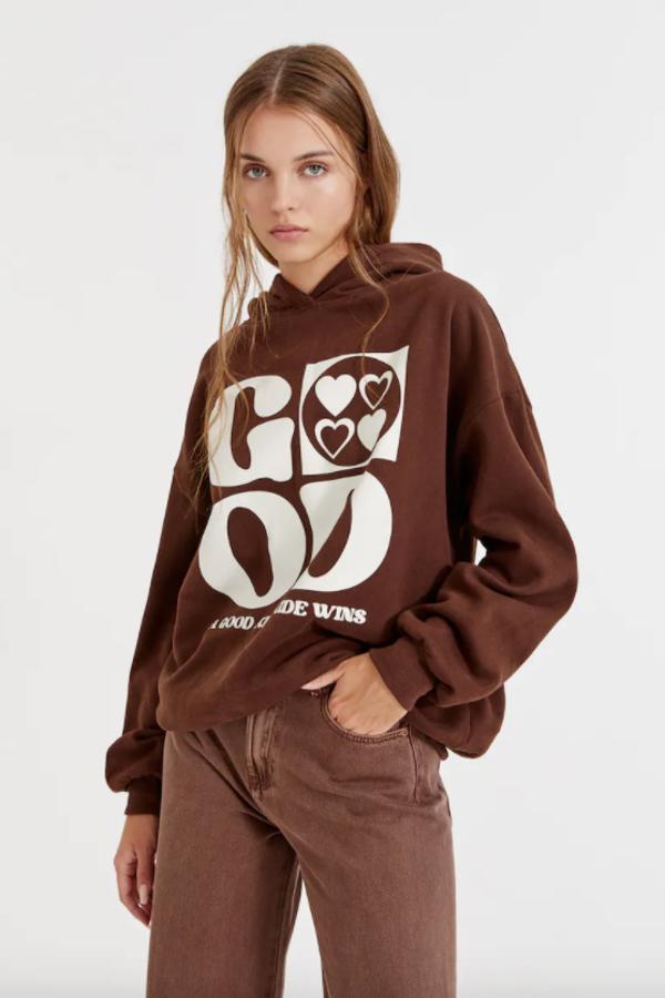 En marrón chocolate, con gráfico a contraste en la parte frontal, esta sudadera con capucha es de Pull&Bear, cuesta 25,99 euros y está disponible entre las tallas XS y XL. 