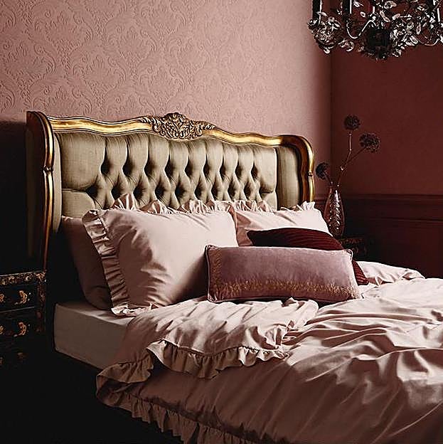 Imagen principal - El conjunto nórdico en satén rosa empolvado con volantes cuesta 30 euros en Primark Home, el estampado con maxi flores, 25 euros, y esta confortable manta en estampado de tartán rojo, 14 euros.