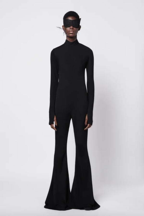 Diseño ajustado con cuello subido para este mono negro de Zara con mangas largas y perneras acabadas en evasé. Cuesta 59,95 euros.
