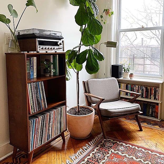 Imagen principal - Copiamos el estilo mid century modern de este salón con unas estanterías de maderas de Zara Home (149 euros) y esta butaca (499 euros)