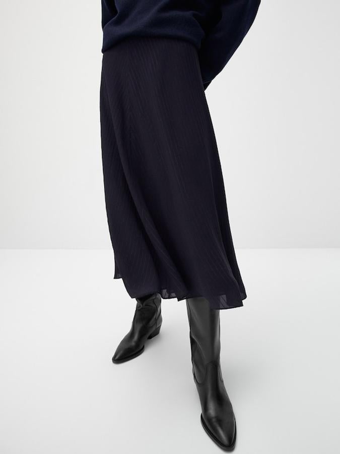 Confeccionada en tejido fluido en color marino y de corte evasé, esta falda midi de Massimo Dutti estructurada y confeccionada en devoré tiene un precio de 79,95 euros y podemos comprarla entre las tallas 34 y 42. 
