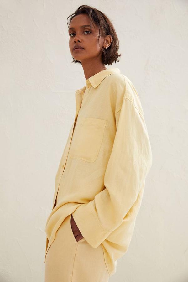 Camisa confeccionada en tejido mezcla de lino, corte relajado, cierre de botones y bolsillos de parche en el pecho, color amarillo pastel, de H&M. ¿Su precio? 24,99 euros.