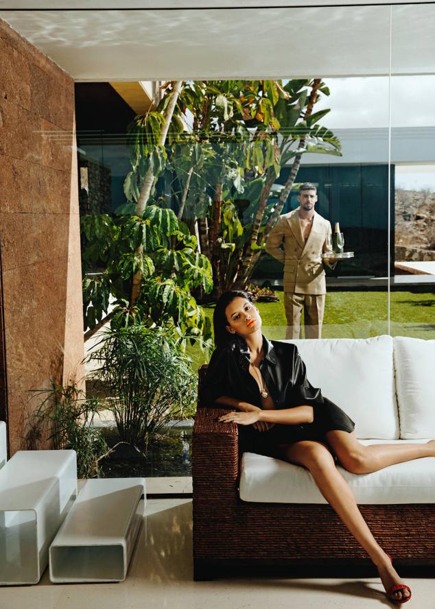 Camisa de Karl Lagerfeld; braguita de biquini, de Aurelia Gil; colgante de Chanel y sandalias de Aquazurra. Él lleva traje de chaqueta cruzada, de Tommy Hilfiger.