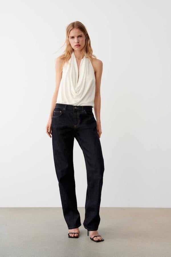 Top halter con escote drapeado y fluido con caída elegante y espalda al aire, color blanco roto, de Zara. Cuesta 17,95 euros.