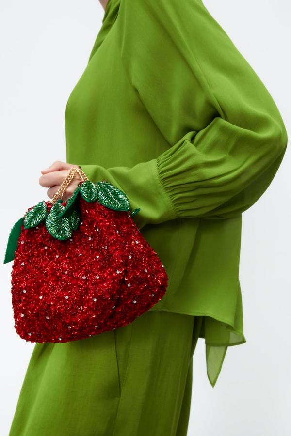 Los bolsos de fiesta llegan con formas completamente inesperadas, como este diseño frutal. Una fresa cubierta de lentejuelas que pondrá el toque divertido a tus estilismos más sofisticados. Bolso de lentejuelas de Zara (35,99 euros) 