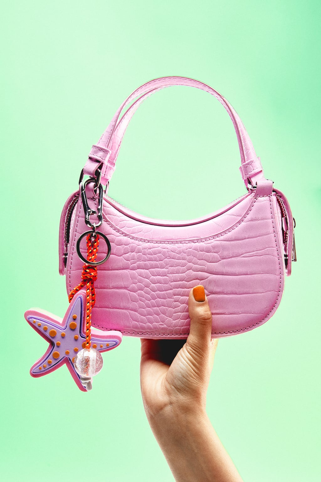 Los mini bolsos se han posicionado como la opción estrella para las noches de verano. Zara apuesta por los colores pastel como el rosa. Bolso de asa corta de Zara (22,99 euros)