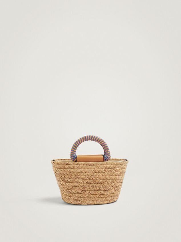 Y para los planes de noche nada mejor que elegir un capazo en versión reducida. Elige un diseño con asa corta y llévalo sin parar todo el verano. Mini bolso de rafia con asa de colores de Parfois (22,99 euros)