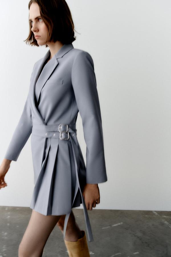 Un diseño a medio camino entre la americana y el vestido con falda de tablas. Mini vestido de color gris de Zara (49,99 euros). 