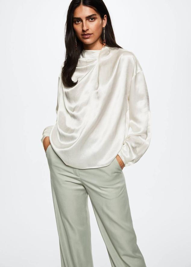 Camisa satinada y fluida con manga larga, corte holgado y cuello drapeado, color blanco, de Mango. Cómprala por 49,99 euros.