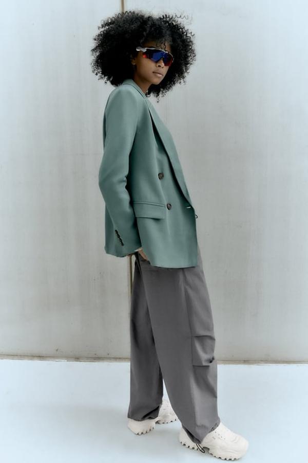 Blazer larga y recta con cuello solapa y manga larga en color menta. Bolsillos con solapa en el delantero y cierre frontal cruzado con botones. Precio: 49,95 euros.