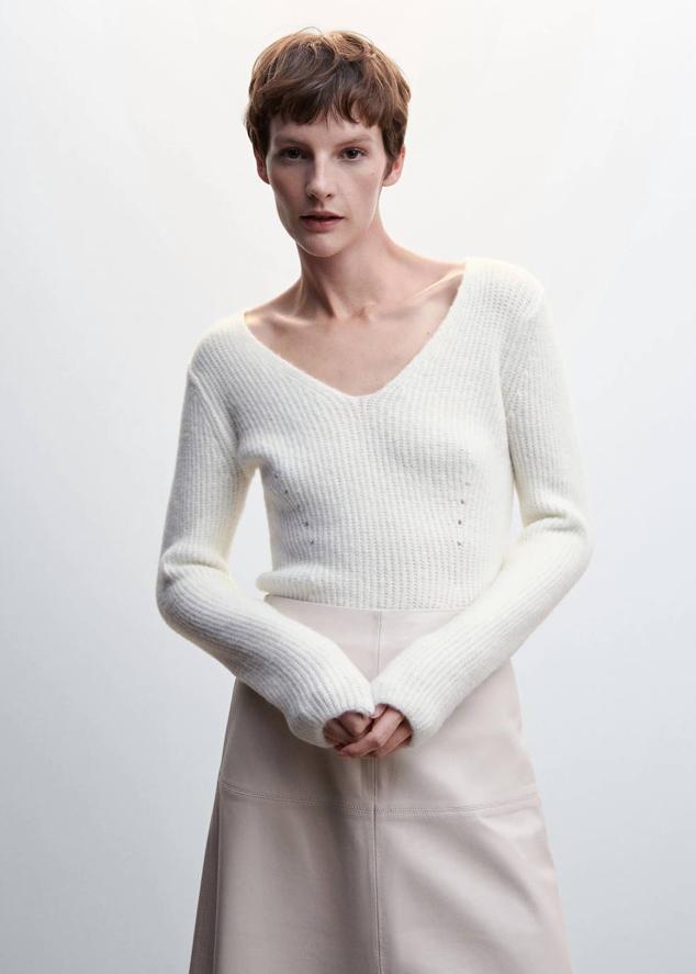 Jersey en tejido de punto mezcla de lana con diseño entallado, manga larga y escote de pico, color blanco, de Mango. Cuesta 25,99 euros.