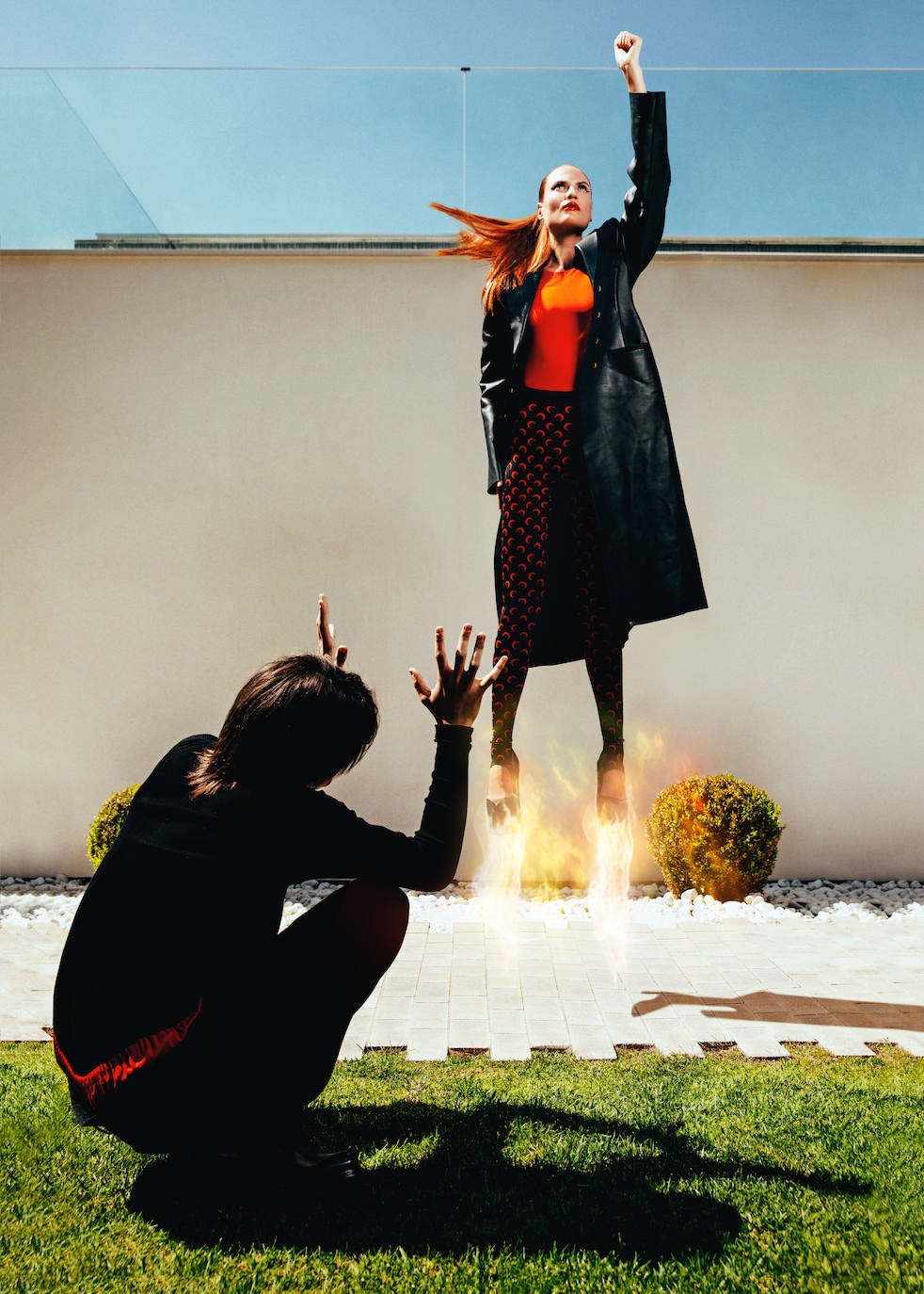 Ella lleva abrigo de cuero, de Versace; body de Lefties; leggings de Marine Serre en Mytheresa; y salones de plataforma, de Valentino. Él, jersey, calzoncillo largo, pantalón de lana y botas de piel, todo de Prada.