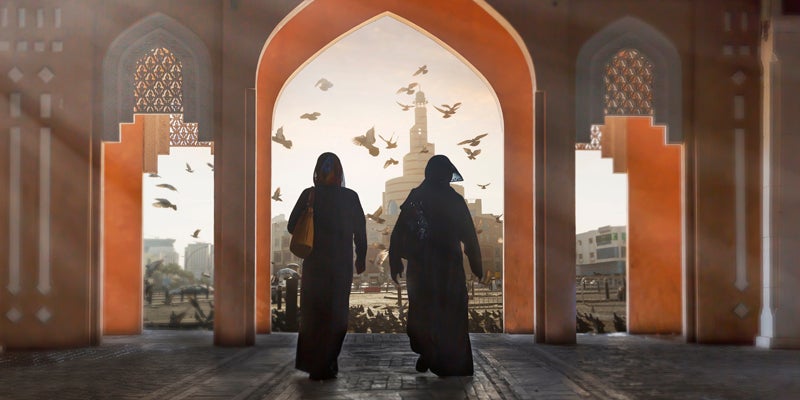 Two arab woman wearing traditional Abaya in a suck.