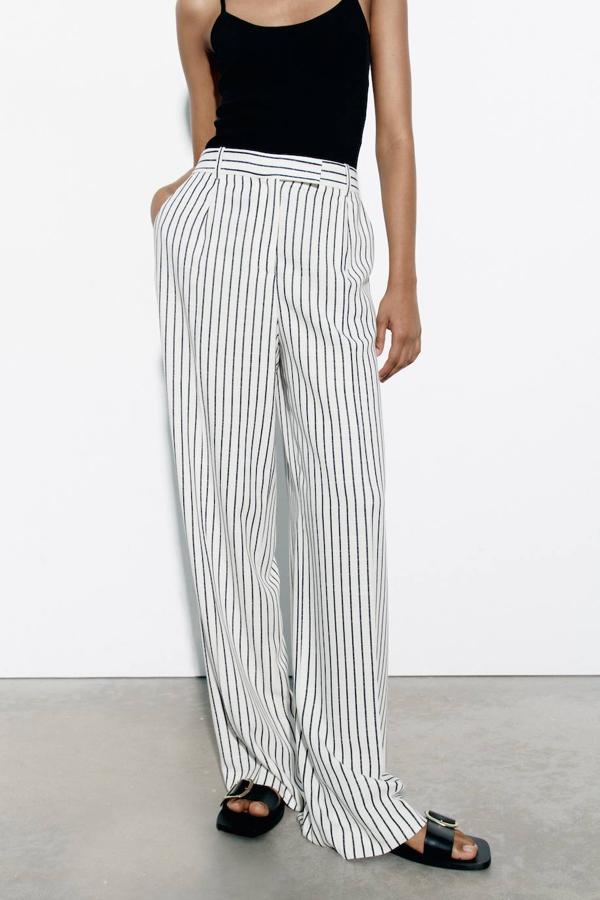Pantalón de traje ancho con tiro alto, pinzas, trabillas para el cinturón y bolsillos, print de rayas finas en blanco y negro, de Zara. Cómpralo por 29,95 euros.