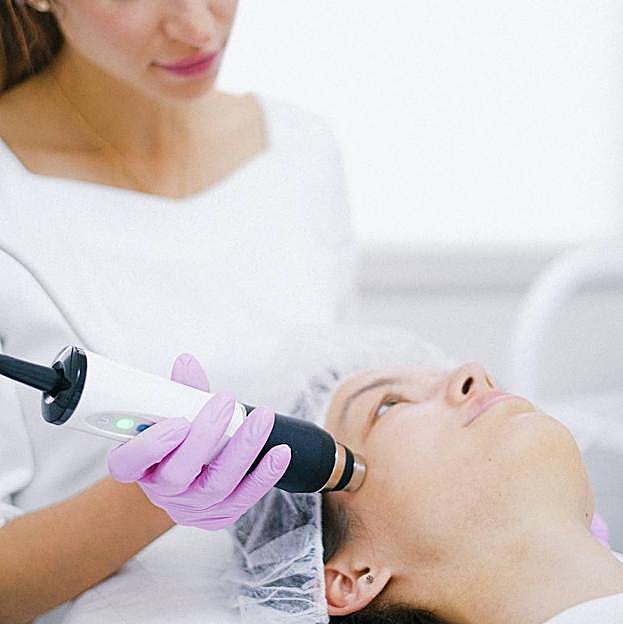 Profesional realizando tratamiento de limpieza facial profunda