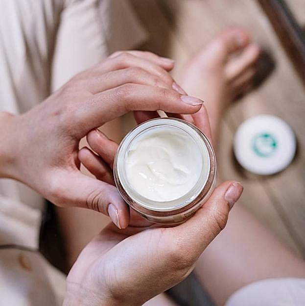 Mujer sujetando crema