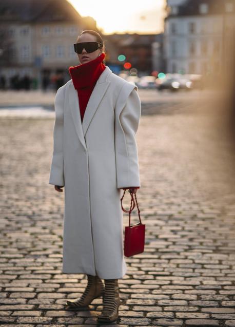 Imagen - Abrigo de color claro combinado con jersey y bolso de color rojo.