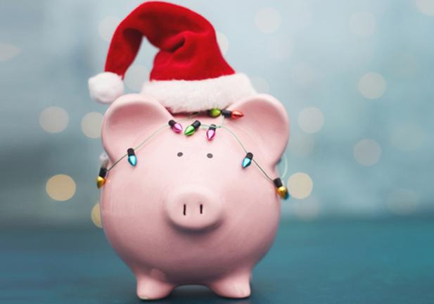 Pink Piggy Bank Wrapped in Holiday Lights and Wearing Santa Hat for Christmas