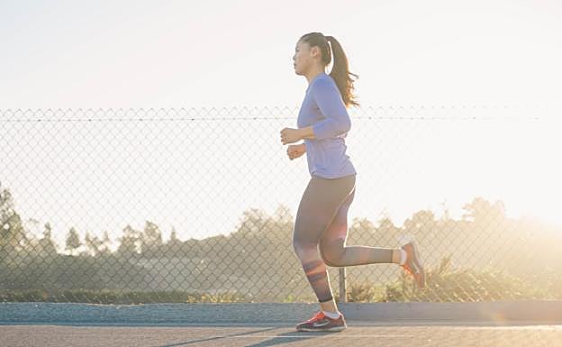 Mujer corriendo al atardecer. /