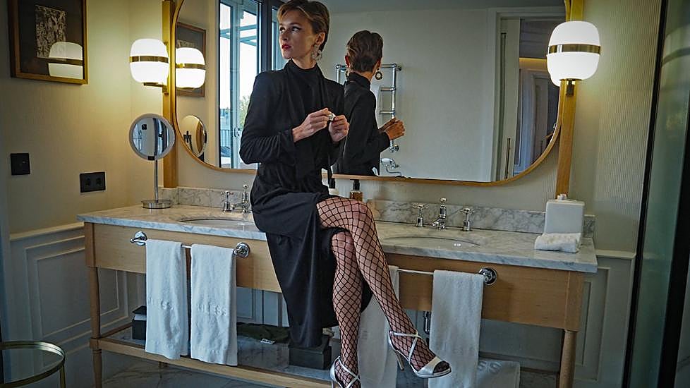 Vestido negro de Woman Limited de El Corte Inglés, pendientes y choker de Tintorretto disponibles en El Corte Inglés, medias de red de Énfasis disponibles en El Corte Inglés, sandalias plateadas de Woman Limited de El Corte Inglés, cinturón de Latouche disponible en El Corte Inglés.